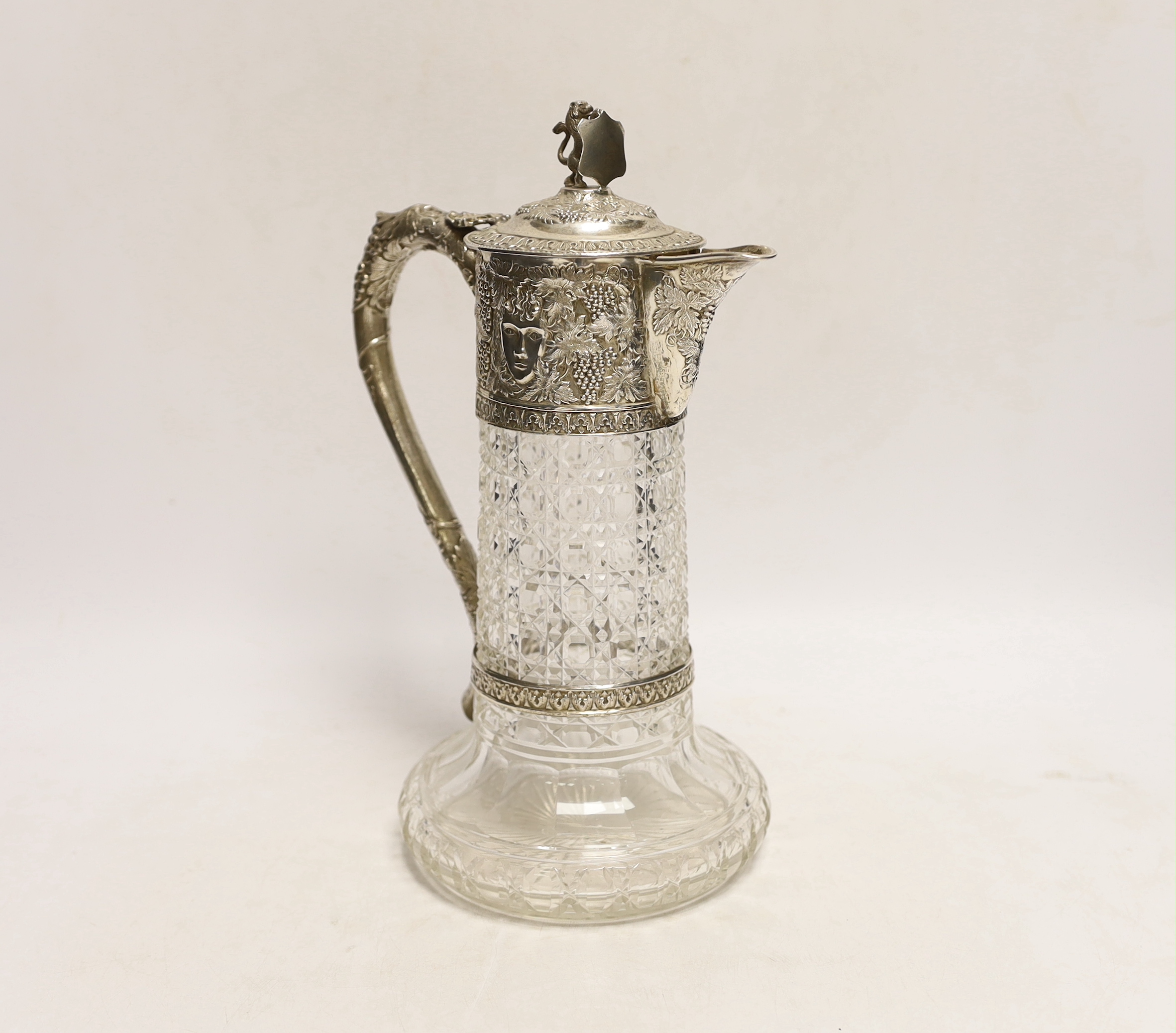 A late Victorian silver mounted cut glass claret jug, by Charles Boyton, London, 1899, the mount with fruiting vine and mask decoration, 27.5cm.